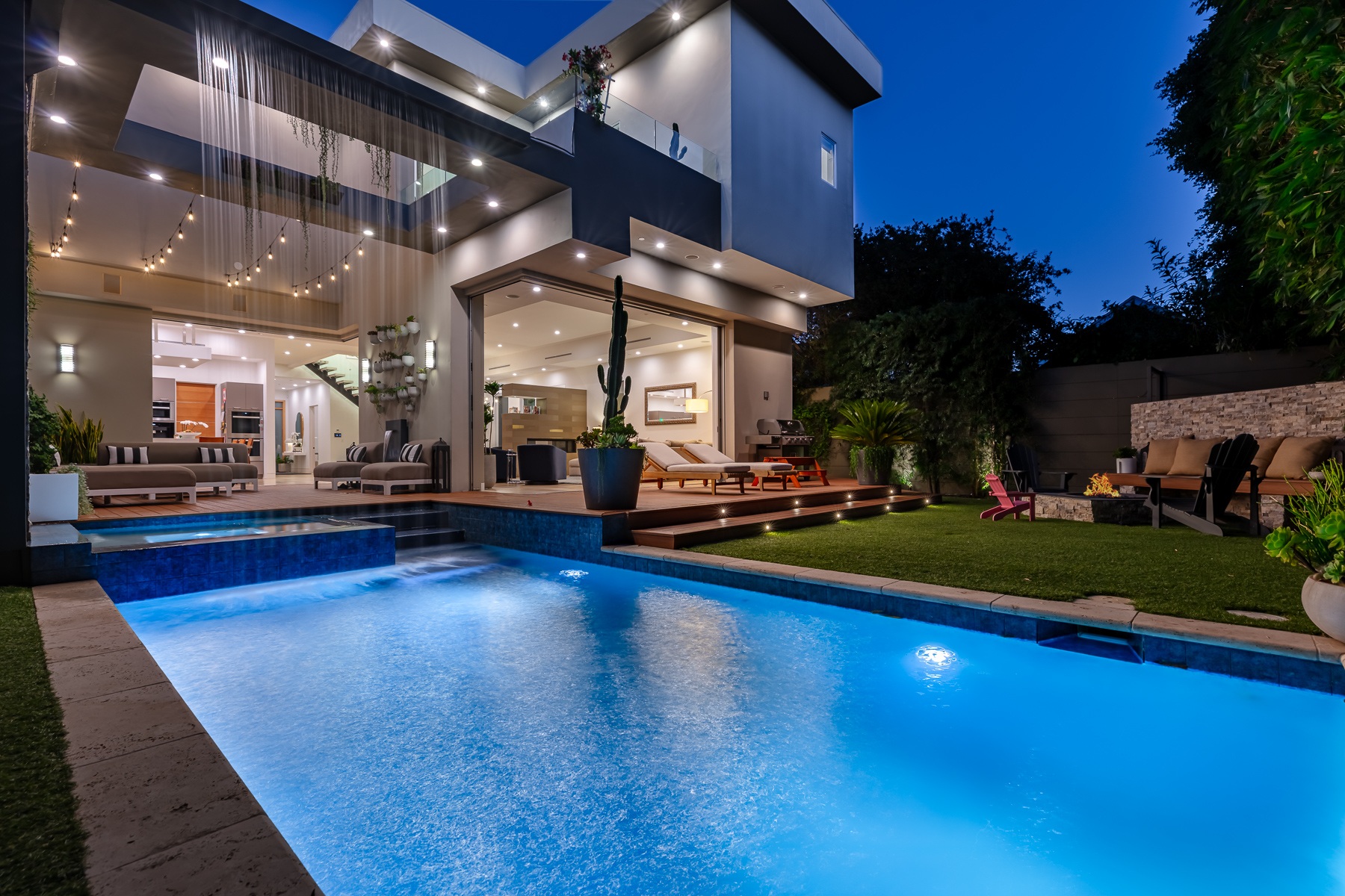 Sierra Bonita backyard waterfall and pool at twilight, actual listing photography